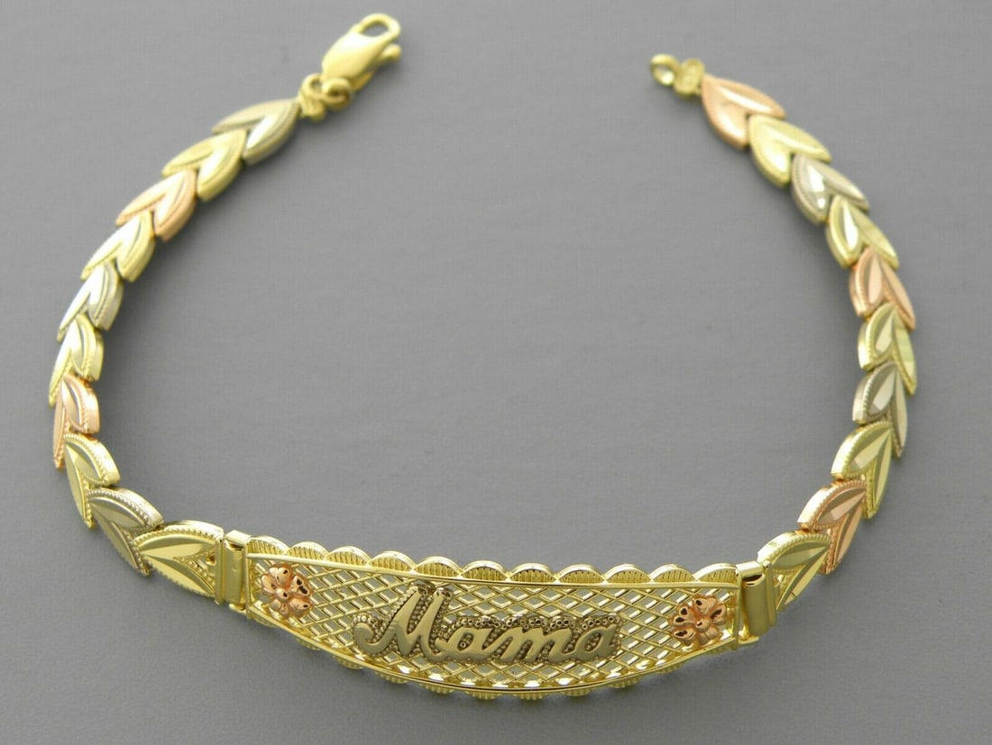NEW 14K TRI COLOR GOLD FLOWER MOM BRACELET: 14K TRI-COLOR GOLD MAMA BRACELET New 14K Tri-Color Gold Measures 6mm wide, 12mm at the widest 7" Long Flower design, Polished finish Lobster Clasp Stamp: 14k Avg Weight: 7" = 9.4g