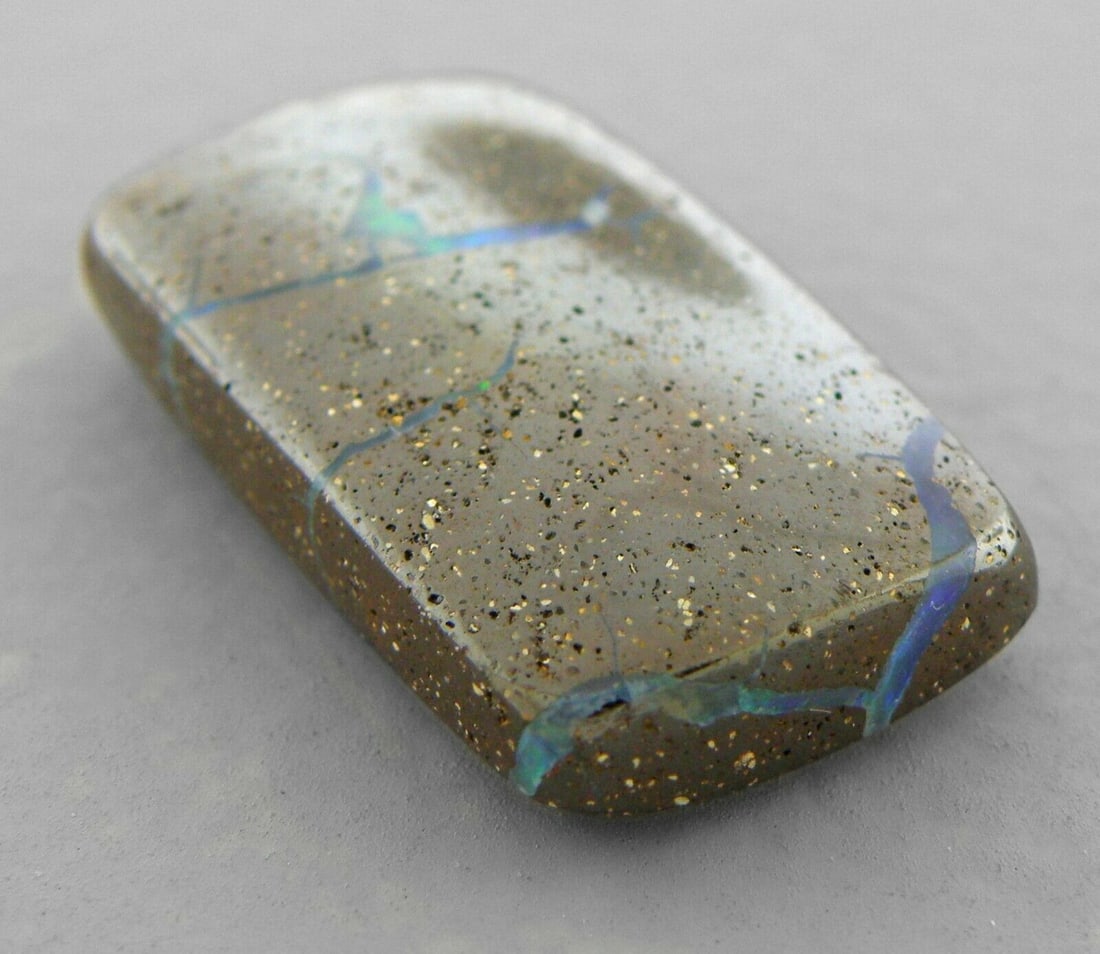 19.85ct LOOSE CABOCHON NATURAL AUSTRALIAN BOULDER OPAL: 19.85ct NATURAL AUSTRALIAN BOULDER OPAL Natural Untreated boulder opal from Australia19.85ct Measures 23.2mm x 13.1mm Polished rectangular shape cabochon, beautiful veins with color play