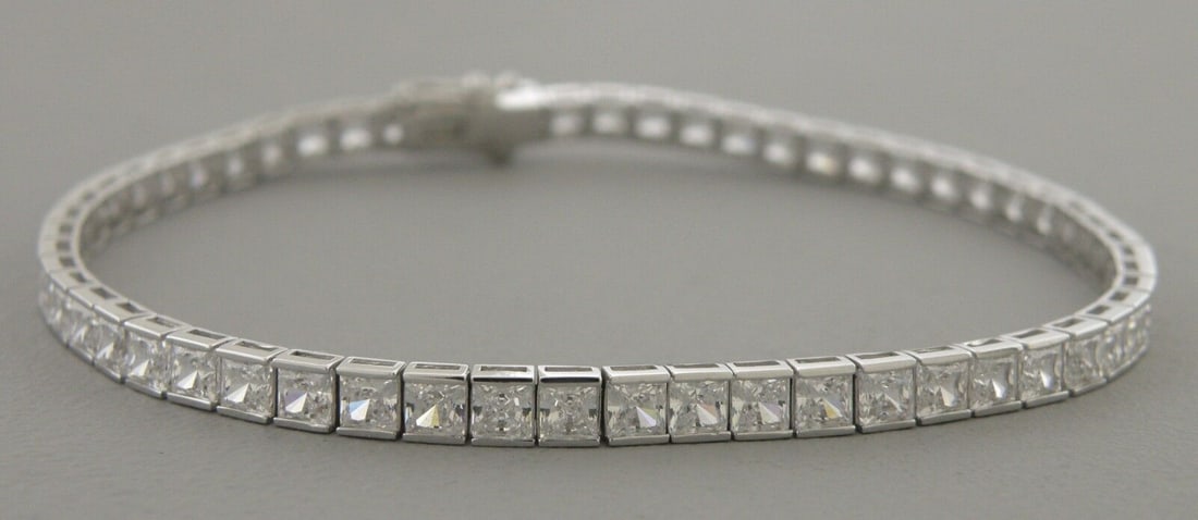 14K WHITE GOLD PRINCESS CUT CZ TENNIS BRACELET: 14K WHITE GOLD BRACELET 14K Solid White Gold Princess cut Cz cubic zirconia Width Size: 2.5mm wide Lengths: 7" High Polish 14k gold with Cubic Zirconia Stamp: 14k Avg Weight: 2.5mm - 7" = 7g