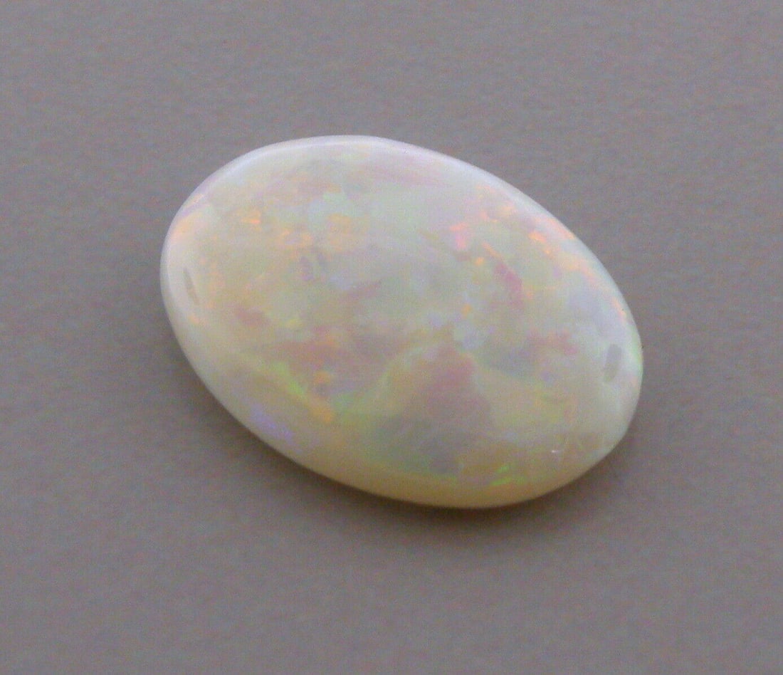 3.93ct LOOSE OVAL CABOCHON NATURAL WHITE OPAL BEAUTIFUL COLORS: 3.93ct NATURAL WHITE OPAL Natural Untreated white opal 3.93ct Measures 15.3mm x 11.6mm x 3.4mm Nice colors, doesn't show well in pictures red, green, blue, purple, orange