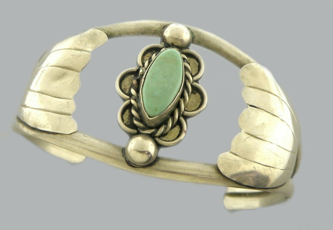 VINTAGE SILVER TURQUOISE CUFF BANGLE BRACELET: VINTAGE TURQUOISE SILVER CUFF BANGLE Turquoise silver cuff silver Mexican Turquoise cuff bangle Measures 2.31" inside length Measures 1.31" wide in front Turquoise measures 0.56" H x 0.26" W Vintage,