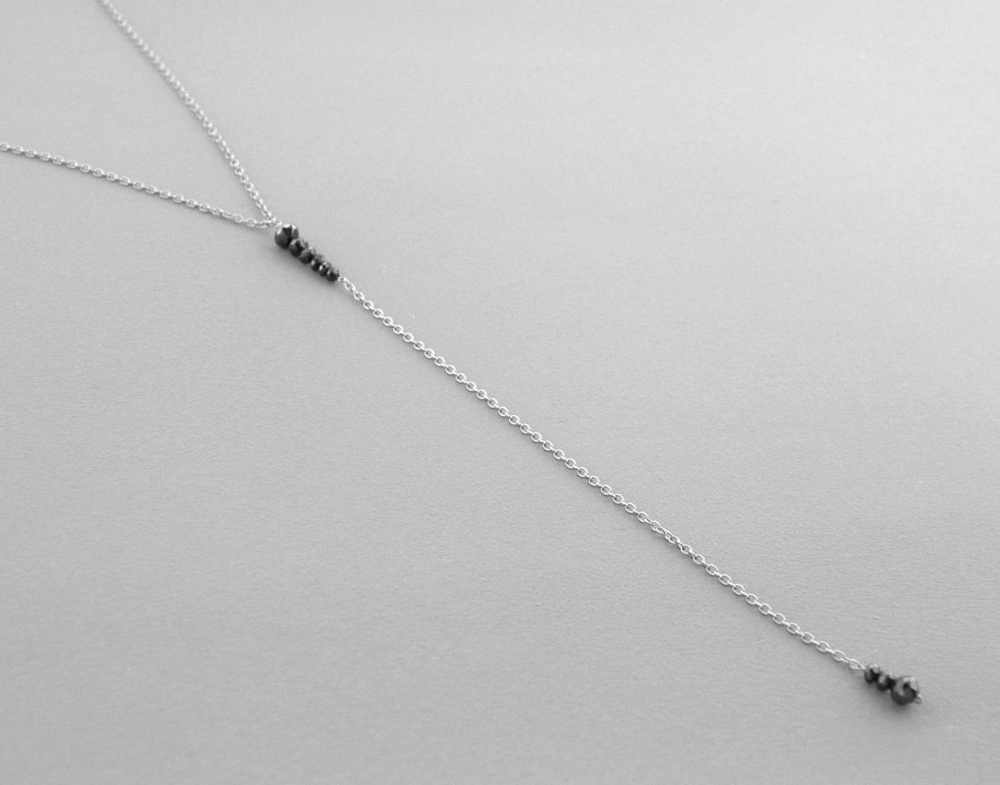 14K WHITE GOLD BLACK DIAMOND LARIAT DROP NECKLACE 20": 14K WHITE GOLD DIAMOND LARIAT NECKLACENecklace measures 20" Long Drop measures 3.6" long14K white gold9 Black Diamonds, Total weight 0.65ctNewStamped 585Total weight 1.4 gramsIf you want this necklace