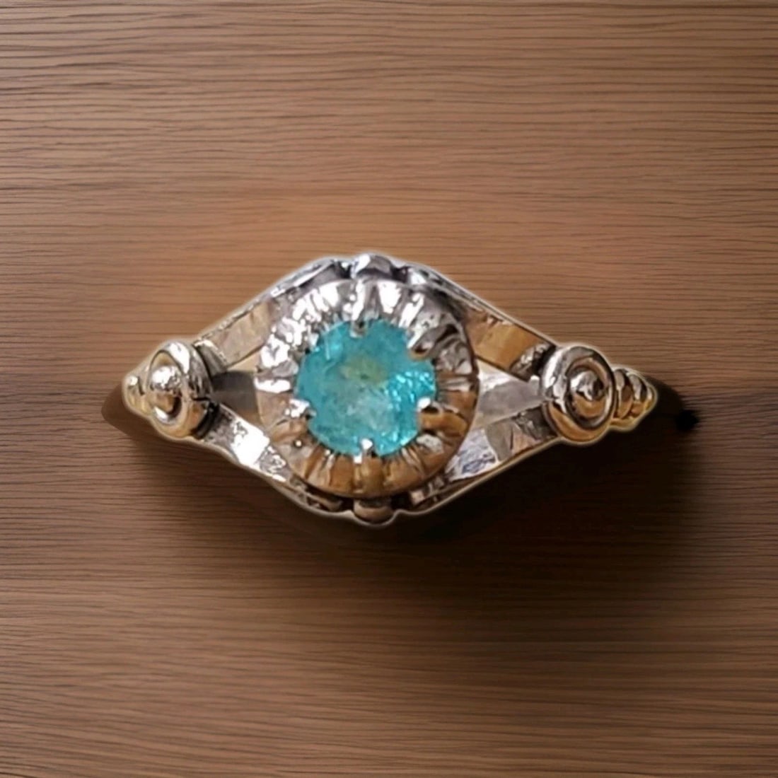 PLATINUM VINTAGE ENGAGEMENT RING 0.38CT.NATURAL BRAZIL PARAIBA ROUND TOURMALINE: PLATINUM VINTAGE ENGAGEMENT RING 0.38CT.NATURAL BRAZIL PARAIBA ROUND TOURMALINE This Platinum Vintage Engagement Ring features a stunning 0.38ct. Natural Brazil Paraiba Tourmaline, certified by GIA. T