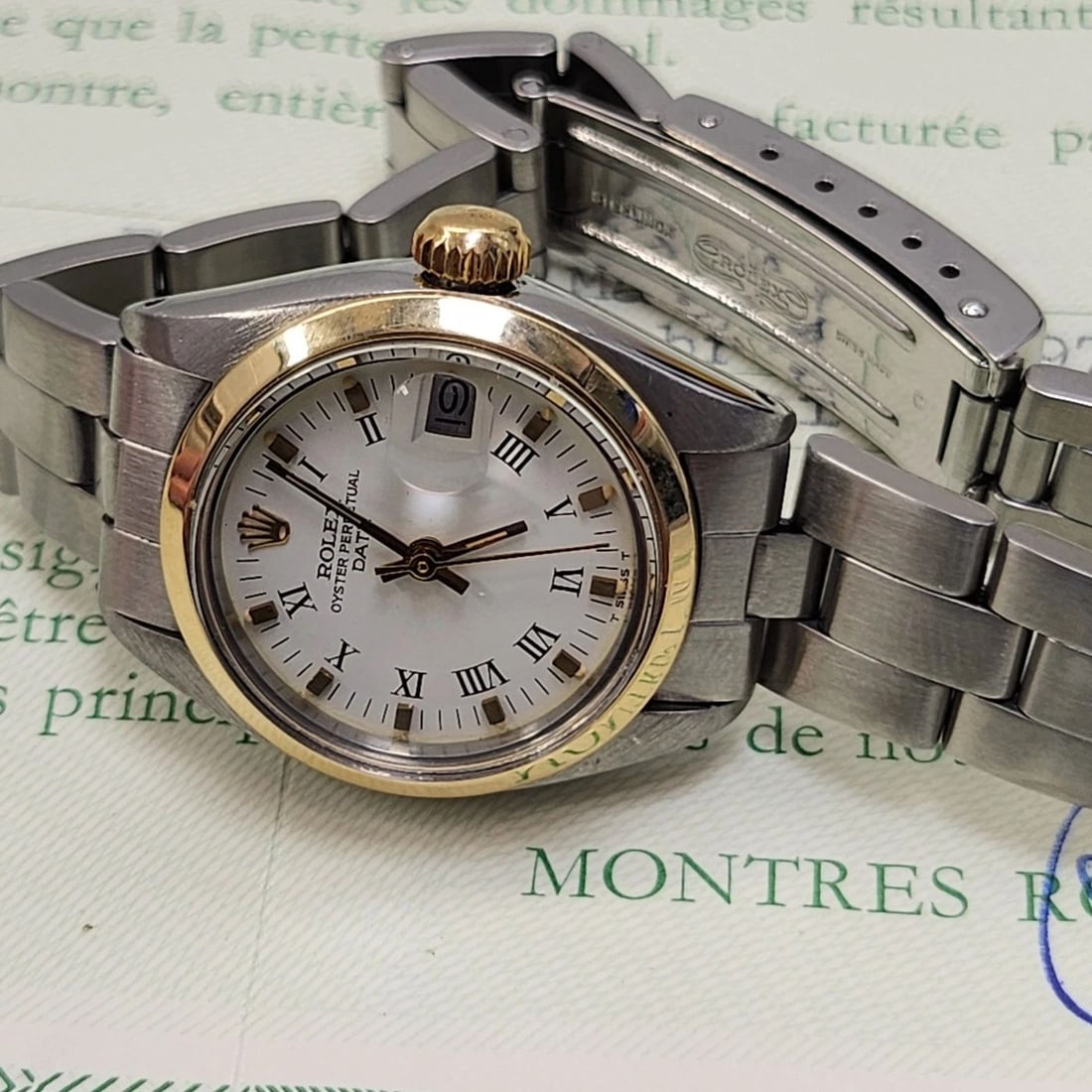 W/PAPERS 1979 ROLEX LADIES DATE 26 MM TWO TONE WHITE ROMAN AUTOMATIC WATCH 6916: W/PAPERS 1979 ROLEX LADIES DATE 26 MM TWO TONE WHITE ROMAN AUTOMATIC WATCH 6916 Condition: Pre-owned - Good: This item has been gently used but is in good condition. It might have a few signs ... Read