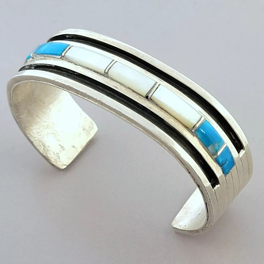 VINTAGE NAVAJO STERLING SILVER CORAL TURQUOISE INLAY CUFF BANGLE: VINTAGE TURQUOISE & MOP STERLING SILVER CUFF Vintage Navajo inlaid turquoise & mop sterling silver cuff bangle Measures 2.28" inside measurement Measures 0.69" Wide in front Vintage, Pre-owned, in goo
