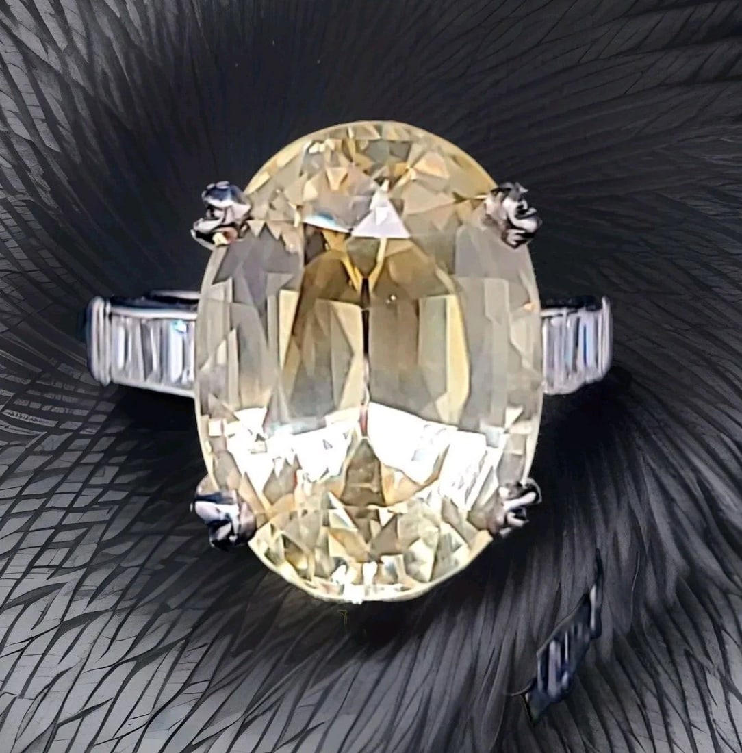 VINTAGE PLATINUM ENGAGEMENT RING 13.23CT. NATURAL YELLOW SAPPHIRE OVAL GIA CERT: VINTAGE PLATINUM ENGAGEMENT RING 13.23CT. NATURAL YELLOW SAPPHIRE OVAL GIA CERT Own a piece of history with this stunning vintage platinum engagement ring. The centerpiece is a breathtaking 13.23ct. n