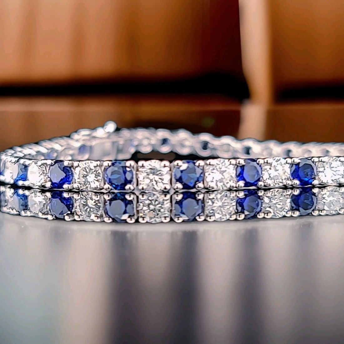 14K WHITE GOLD TENNIS BRACELET 12.52CT. ROUND BLUE SAPPHIRE NATURAL DIAMONDS: 14K WHITE GOLD TENNIS BRACELET 12.52CT. ROUND BLUE SAPPHIRE NATURAL DIAMONDS This 14k White Gold Tennis Bracelet features 12.52ct. Of round blue diffused treated sapphire and natural diamond accents.