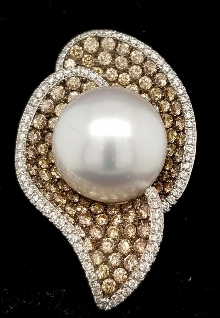 18K WHITE GOLD 3.82CT. NATURAL CHOCOLATE DIAMOND ROUND PEARL RING: 18K WHITE GOLD 3.82CT. NATURAL CHOCOLATE DIAMOND ROUND PEARL RING Gorgeous 18k White gold diamond pearl ring center natural south sea pearl size 16mm round shape. side set round diamonds weight 0.62ct