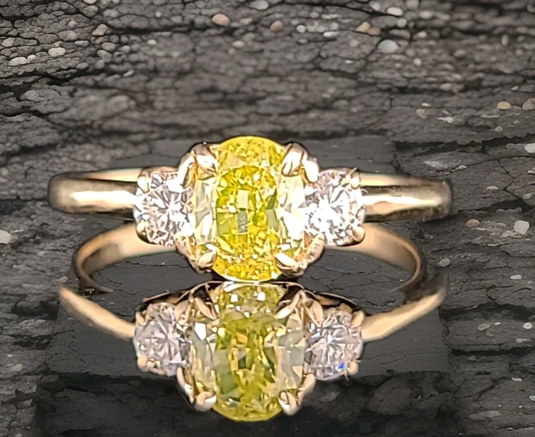 14K YELLOW GOLD RING 1.01CT.NATURAL FANCY INTENSE YELLOW DIAMOND OVAL GIA CERT: 14K YELLOW GOLD RING 1.01CT.NATURAL FANCY INTENSE YELLOW DIAMOND OVAL GIA CERT This 14k Yellow Gold Ring features a 1.01CT Natural Fancy Intense Yellow Diamond in an Oval shape, accented with three ad