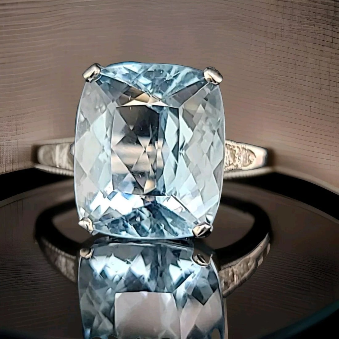 VINTAGE 14K WHITE GOLD ENGAGEMENT RING 13.55CT. NATURAL AQUAMARINE CUSHION CUT: VINTAGE 14K WHITE GOLD ENGAGEMENT RING 13.55CT. NATURAL AQUAMARINE CUSHION CUT This vintage 14k white gold ring boasts a stunning 13.55ct natural aquamarine in a cushion cut. The ring is resizable and