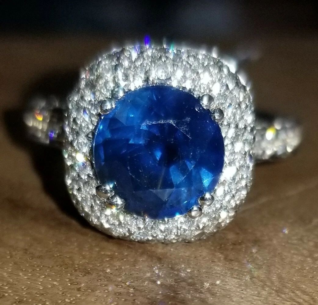 18K WHITE GOLD ENGAGEMENT RING 3.27CT. NATURAL BLUE SAPPHIRE ROUND SHAPE: 18K WHITE GOLD ENGAGEMENT RING 3.27CT. NATURAL BLUE SAPPHIRE ROUND SHAPE GORGEOUS 18K WHITE & YELLOW GOLD natural blue Sapphire round shape center weight 2.01ct. size 8.1mm very nice rich royal blue c