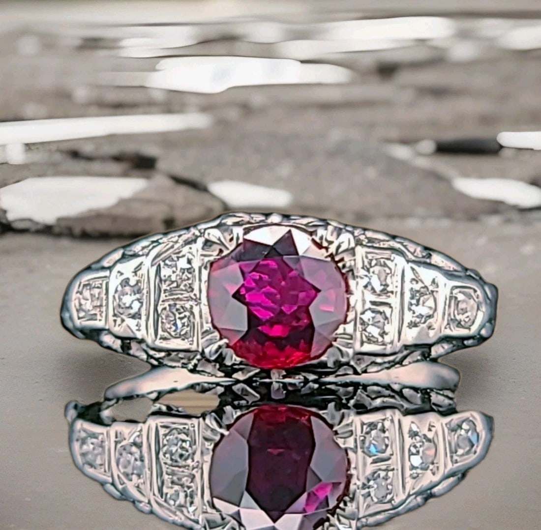 VINTAGE 14K WHITE GOLD ENGAGEMENT RING 0.71CT. NATURAL OVAL SHAPE RUBY GIA CERT: VINTAGE 14K WHITE GOLD ENGAGEMENT RING 0.71CT. NATURAL OVAL SHAPE RUBY GIA CERT This vintage filigree 14k white gold engagement ring features a stunning natural cushion ruby with a total carat weight