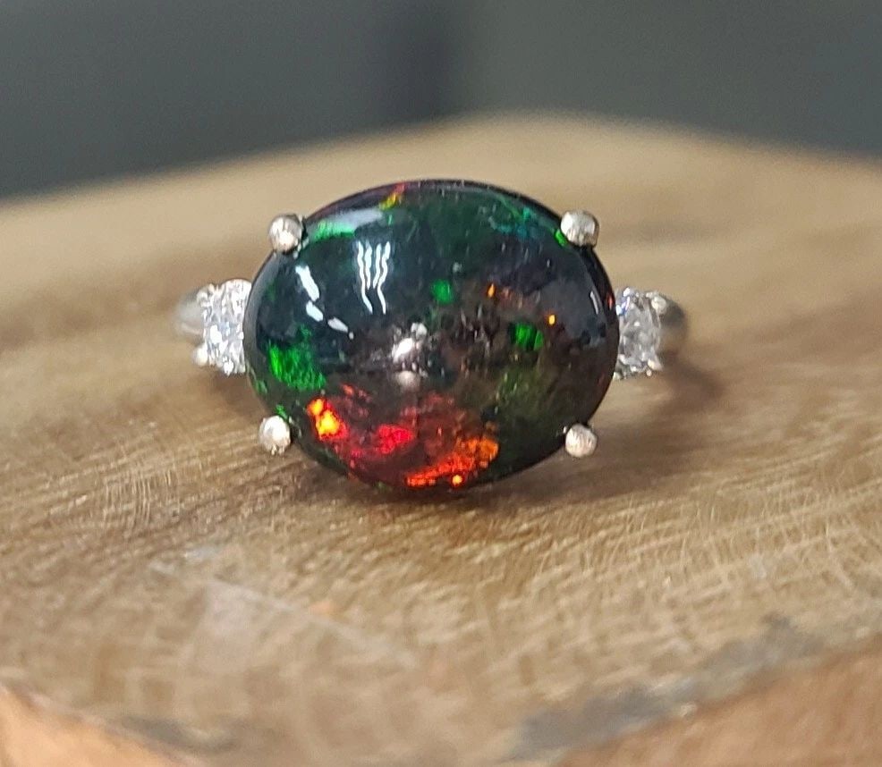 VINTAGE 14K WHITE GOLD ENGAGEMENT RING 3.75CT. NATURAL ETHIOPIAN OPAL CABOCHON: VINTAGE 14K WHITE GOLD ENGAGEMENT RING 3.75CT. NATURAL ETHIOPIAN OPAL CABOCHON Vintage 14K WHITE GOLD OPAL RING CENTER SET NATURAL BLACK ETHIOPIAN OVAL CABOCHON SHAPE WEIGHT 3.75CARAT SIZE 13x10.8MM N