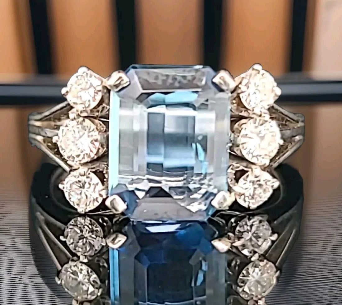 VINTAGE 18K WHITE GOLD ENGAGEMENT RING 2.02CT. NATURAL AQUAMARINE EMERALD SHAPE: VINTAGE 18K WHITE GOLD ENGAGEMENT RING 2.02CT. NATURAL AQUAMARINE EMERALD SHAPE This vintage 18k white gold engagement ring is a true gem, featuring a stunning 2.02ct natural aquamarine gemstone in an