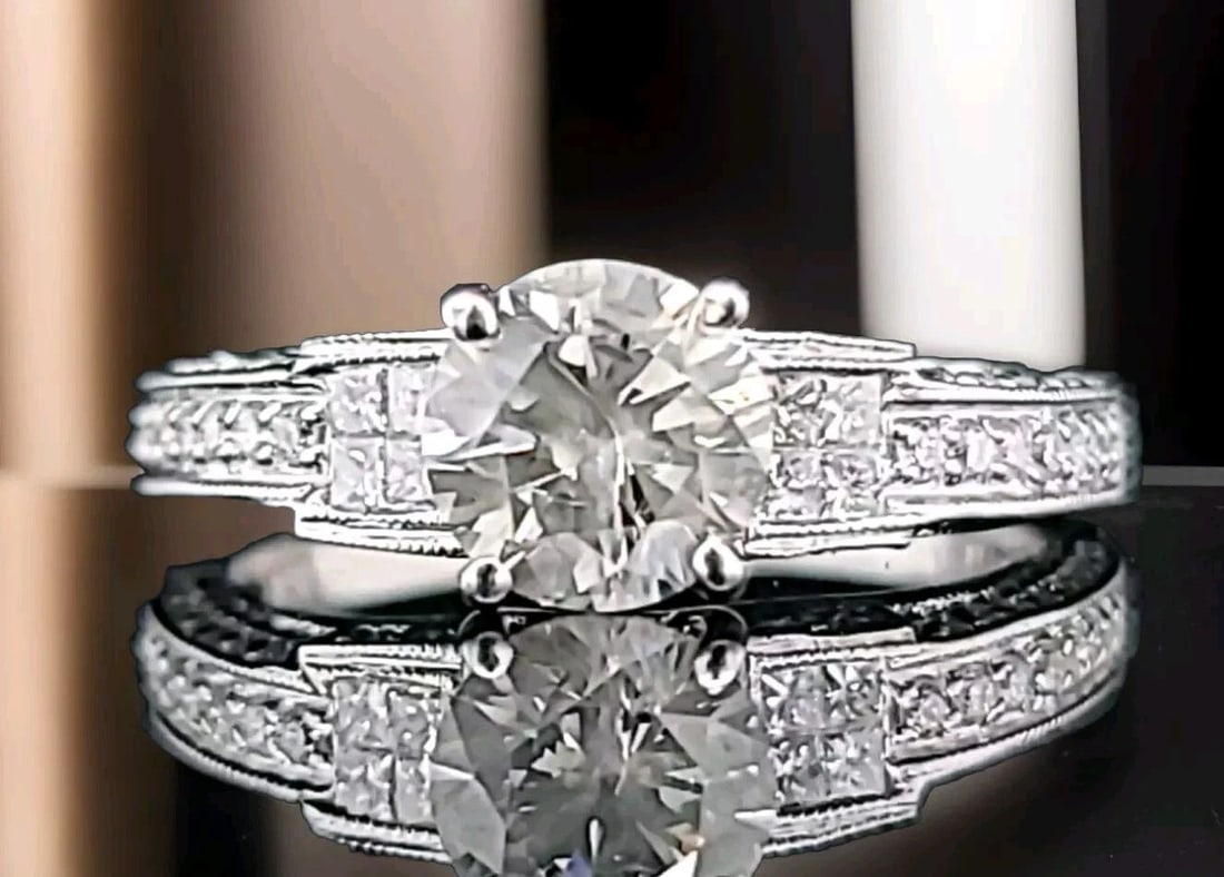 VINTAGE 18K WHITE GOLD ENGAGEMENT RING 1.20CT. NATURAL ROUND LIGHT GRAY DIAMOND: VINTAGE 18K WHITE GOLD ENGAGEMENT RING 1.20CT. NATURAL ROUND LIGHT GRAY DIAMOND This vintage 18k white gold engagement ring is a stunning piece that will make any occasion special. The ring features a