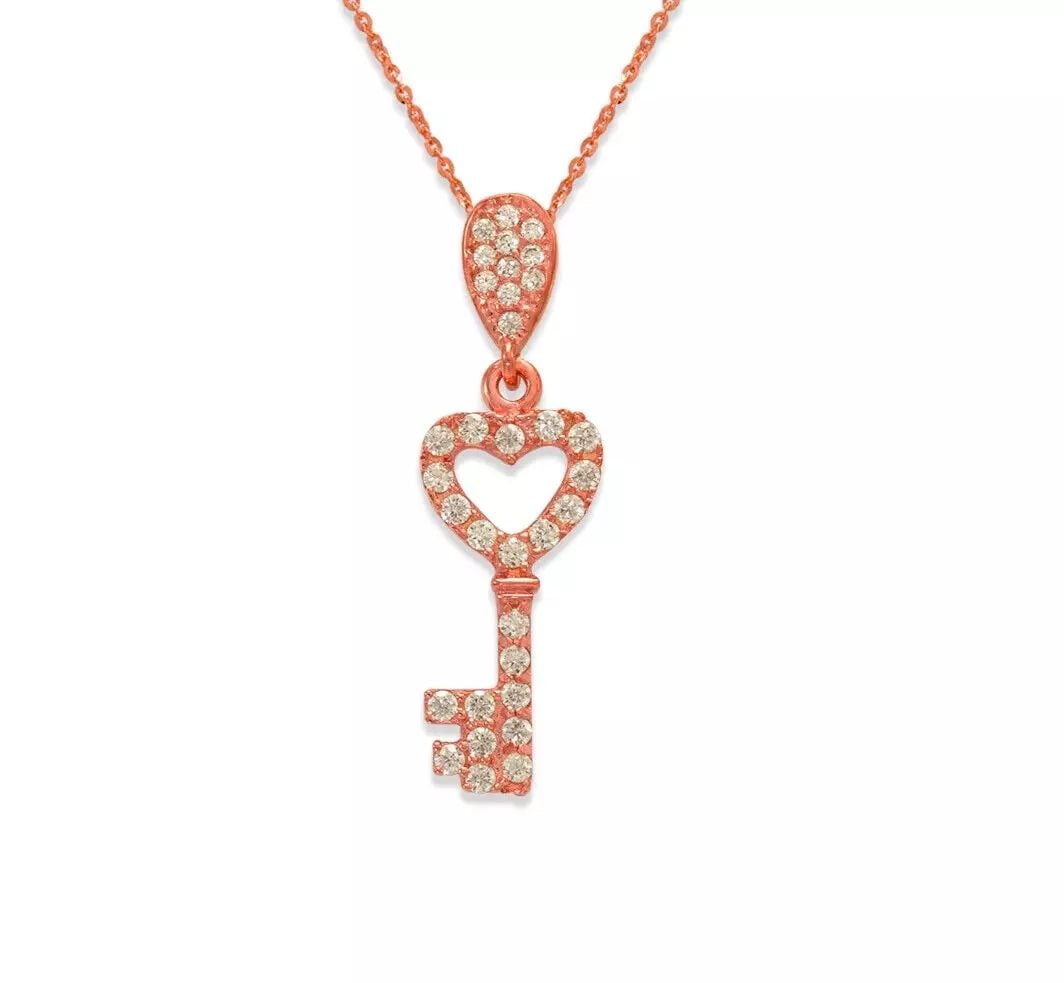NEW 14K ROSE GOLD FANCY ROSE HEART KEY CZ PENDANT: NEW 14K YELLOW GOLD FANCY HEART CZ PENDANT 14K Yellow Gold Approx. 16x13mm High Polished/Cubic Zirconia Available in Rose and White Gold Chains Sold Separately Weight: 0.9 Grams