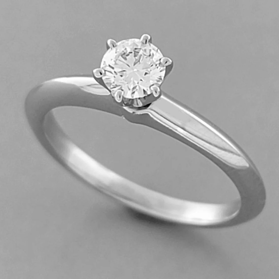 TIFFANY & Co. PLATINUM 0.24ct DIAMOND ENGAGEMENT RING BOX: TIFFANY & Co. PLATINUM DIAMOND ENGAGEMENT RING Ring size is a 3.5 (can easily be sized by your local jeweler) Tiffany & Co. knife edge platinum diamond engagement ring Diamond is 0.24ct Diamond qualit