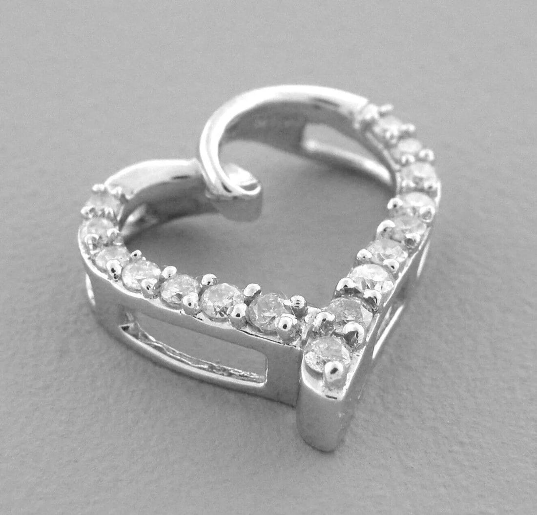 14K WHITE GOLD LADIES DIAMOND OPEN HEART PENDANT: 14K WHITE GOLD DIAMOND HEART PENDANT Pendant measures 0.55" H x 0.55" W 14K white gold 16 round Diamonds, total diamond weight apx 0.30ct Diamonds Color H clarity I1 Pre-owned in excellent condition,
