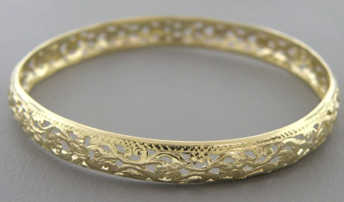 14K YELLOW GOLD LADIES MOROCCAN BANGLE BRACELET FLOWER DESIGN HEAVY: 14K YELLOW GOLD LADIES BANGLE Bangle measures 8" Long (will fit upto 8" wrist) Bangle measure apx 8.8mm Wide 14K Yellow Gold Moroccan Bangle Pre-owned in Excellent condition, please refer to pcs Tests