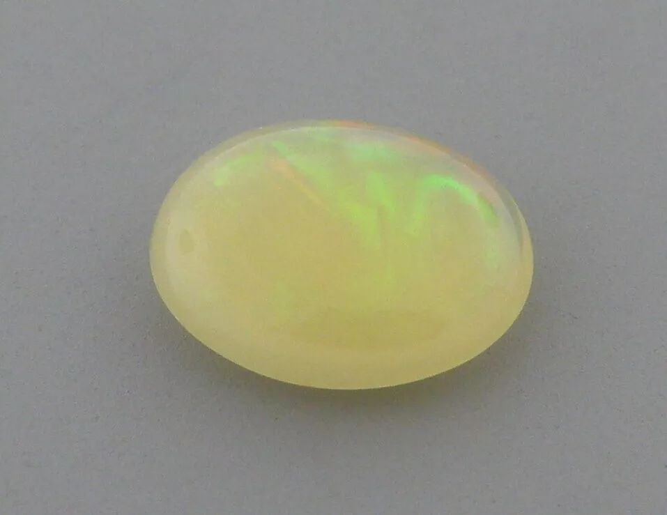 1.33ct EXCELLENT OVAL CABOCHON CUT NATURAL UNTREATED OPAL: 1.33ct EXCELLENT OVAL CABOCHON CUT NATURAL UNTREATED OPAL LOOSE NATURAL UNTREATED OVAL CABOCHON WHITE OPAL Opal measures 10.3x8.1x3.3mm Natural untreated White Opal New Beautiful color play, red, gree