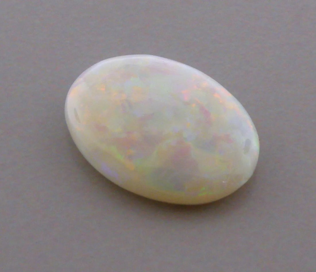 3.93ct LOOSE OVAL CABOCHON NATURAL WHITE OPAL BEAUTIFUL COLORS: 3.93ct NATURAL WHITE OPAL Natural Untreated white opal 3.93ct Measures 15.3mm x 11.6mm x 3.4mm Nice colors, doesn't show well in pictures red, green, blue, purple, orange