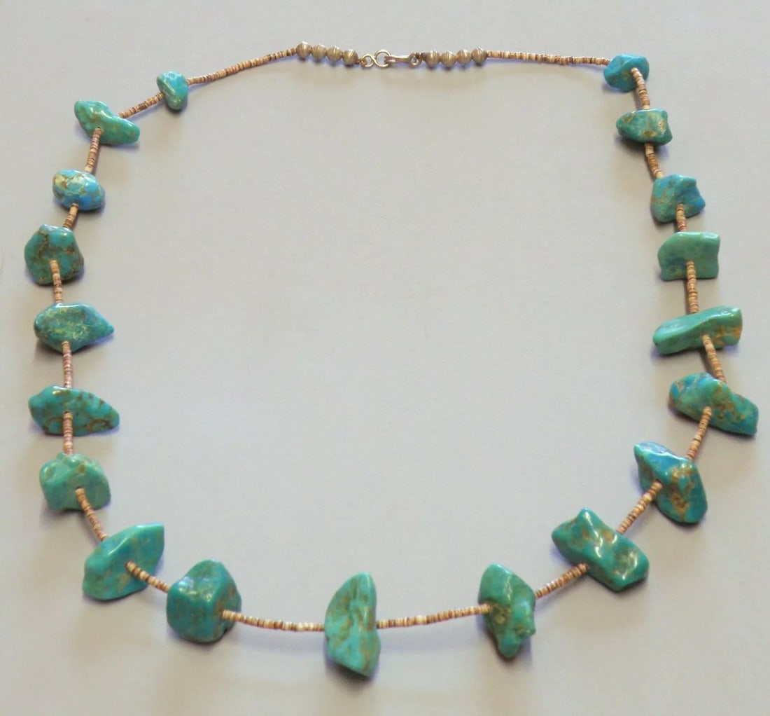 VINTAGE BEAUTIFUL NAVAJO STERLING SILVER HEISHI NUGGET TURQUOISE NECKLACE LARGE: VINTAGE TURQUOISE STERLING SILVER NECKLACE Vintage Navajo sterling silver Nugget Turquoise necklace with Heishi beads 19 large Turquoise nuggets Measures 27" Long Center nuggets 1", slightly smaller a
