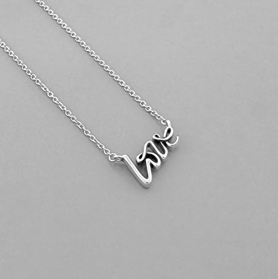 TIFFANY & CO. STERLING SILVER PALOMA PICASSO LOVE GRAFFITI NECKLACE: TIFFANY & CO. STERLING SILVER NECKLACE Tiffany & Co. Sterling silver Paloma Picasso Grafitti Love Necklace Measures 16.5" Long Pendant measures 0.54" Wide x 0.35" High Pre-owned, in good condition, pl