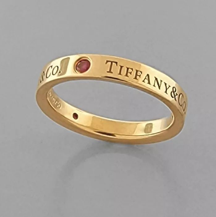 TIFFANY & Co. 18K ROSE GOLD RUBY WEDDING BAND RING POUCH: TIFFANY & Co. 18K RUBY WEDDING BAND RING SIZE 5.5 Ring size is a 5.5 Ring measures 3mm wide Tiffany & Co. 18K rose gold wedding band Set with 3 rubies Pre-owned in Excellent condition, please refer to