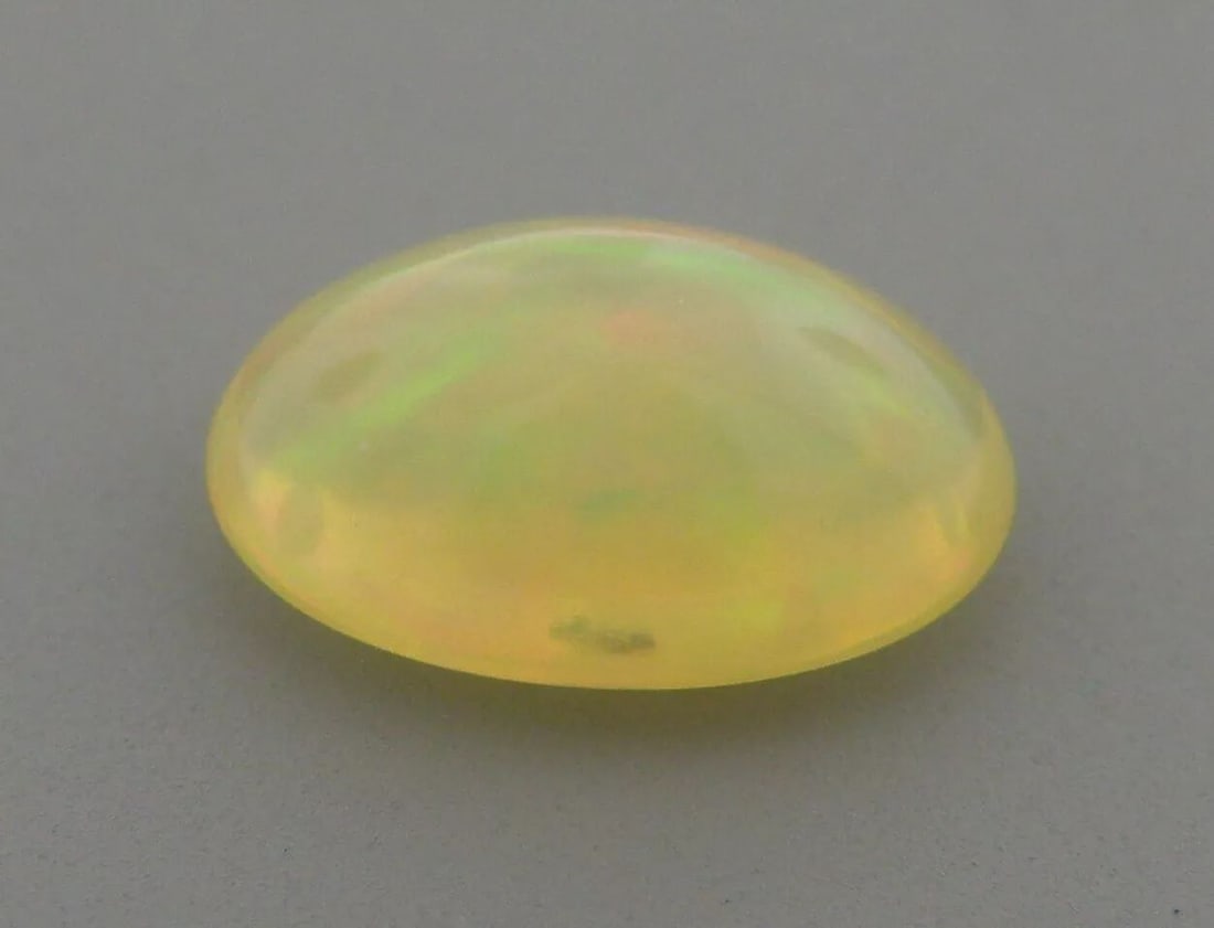 1.47ct EXCELLENT OVAL CABOCHON CUT NATURAL UNTREATED OPAL: 1.47ct EXCELLENT OVAL CABOCHON CUT NATURAL UNTREATED OPAL LOOSE NATURAL UNTREATED OVAL CABOCHON WHITE OPAL Opal measures 10.3x7.2x4.3mm Natural untreated White Opal New Beautiful color play, red, gree