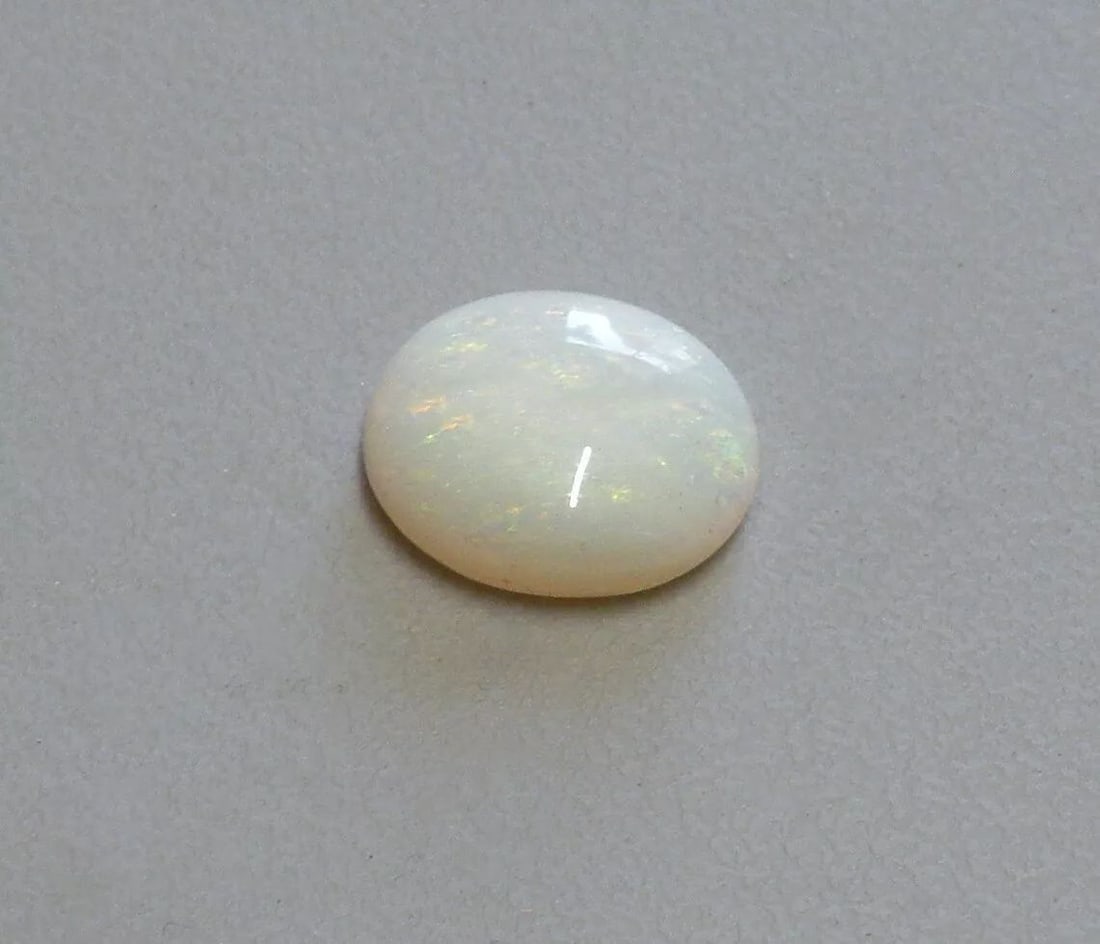3.74ct LOOSE OVAL CABOCHON NATURAL WHITE OPAL 13x11mm: 3.74ct NATURAL WHITE OPAL Natural Untreated white opal 3.74ct Measures 14mm x 11mm x 4.2mm Nice colors, doesn't show well in pictures