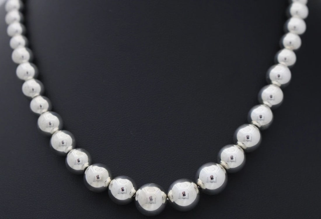 TIFFANY & CO. GRADUATED STERLING SILVER BALL BEADED NECKLACE 16.25": TIFFANY & CO. GRADUATED STERLING SILVER BALL BEADED NECKLACE 16.25" Description Tiffany & Co. Sterling Silver Ball Beaded Necklace 16" Necklace is in good condition. May show signs of wear and/or tear