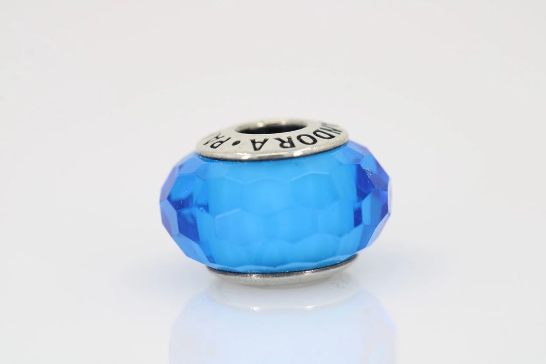 PANDORA S925 ALE BLUE FACETED GLASS MURANO CHARM # 791067: PANDORA S925 ALE BLUE FACETED GLASS MURANO CHARM # 791067 Description Pandora S925 ALE Blue Faceted Glass Murano Charm # 791067 "Two charms available. One charm per purchase price." Item is in good co