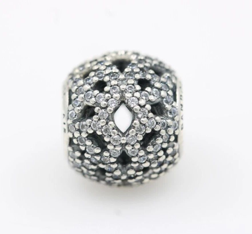 AUTHENTIC PANDORA STERLING SILVER SHIMMERING LACE CHARM 791284CZ: AUTHENTIC PANDORA STERLING SILVER SHIMMERING LACE CHARM 791284CZ Description Authentic Pandora Sterling Silver Shimmering Lace Charm 791284CZ "Two charms available. One charm per purchase price." Pand