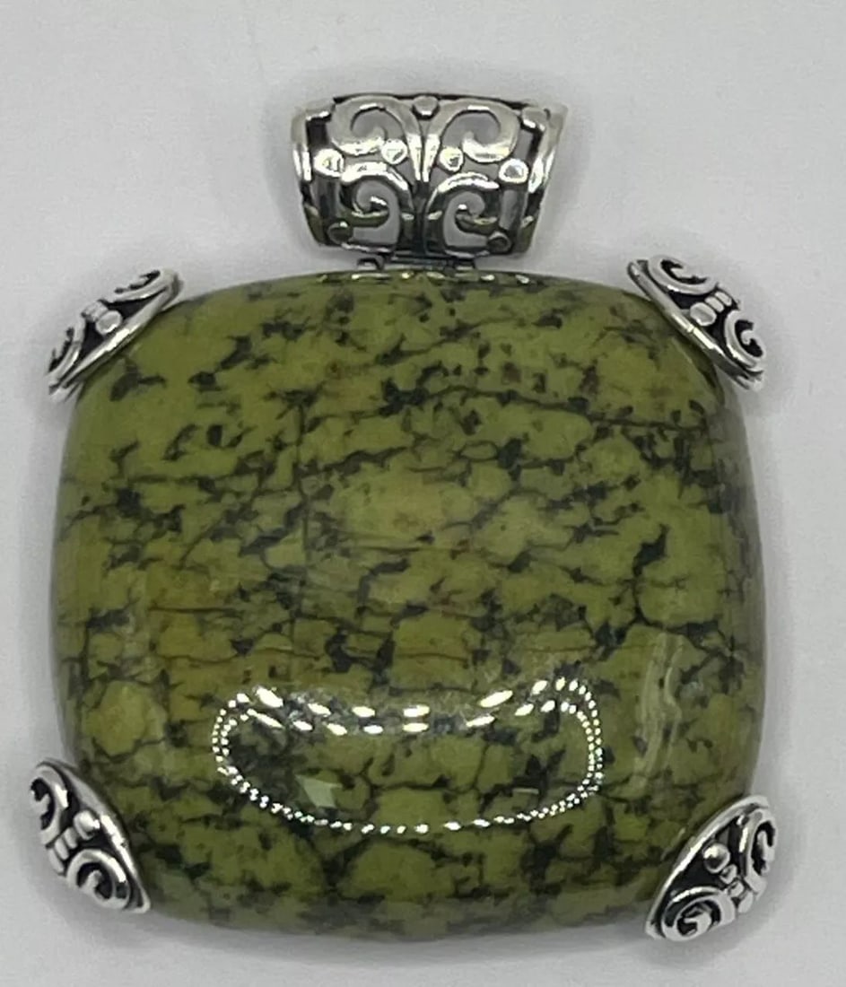 LARGE MIDWEST AMBER PENDANT 58.1 GRAMS: LARGE MIDWEST AMBER PENDANT 58.1 GRAMS This large Midwest Amber pendant weighs 58.1 grams and features a square-shaped green Amber gemstone set in sterling silver with turquoise accents. The necklace