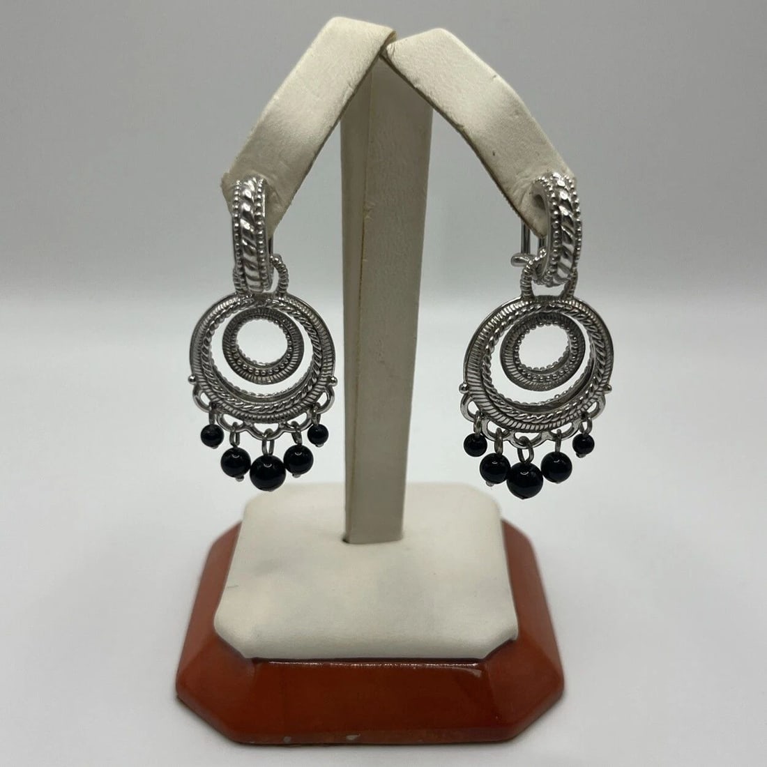 JUDITH RIPKA STERLING BLACK ONYX HOOP EARRINGS: JUDITH RIPKA STERLING BLACK ONYX HOOP EARRINGS Elevate your jewelry collection with these stunning Judith Ripka black onyx hoop earrings. The gemstone is beautifully set in fine silver, giving the ear
