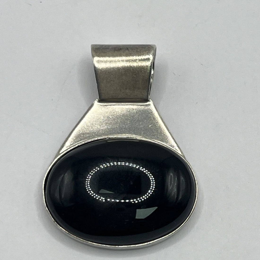 MEXICO TAXCO STERLING SILVER & BLACK ONYX PENDANT ON SNAKE CHAIN 19.5": MEXICO TAXCO STERLING SILVER & BLACK ONYX PENDANT ON SNAKE CHAIN 19.5" This Mexico Taxco pendant features a striking oval black onyx stone set in 925 sterling silver. The design includes a pendant att