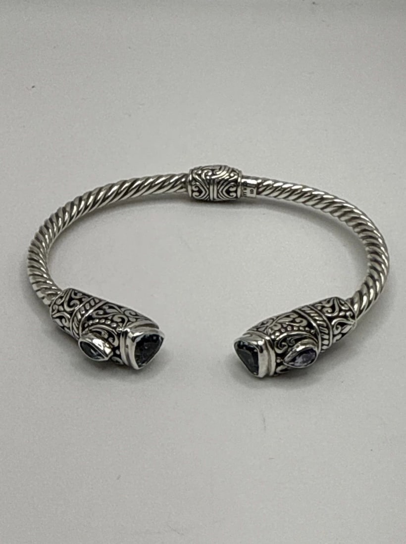 ANNIKA WITT BALI ATI 925 STERLING SILVER HINGED BLUE TOPAZ CABLE CUFF BRACELET: ANNIKA WITT BALI ATI 925 STERLING SILVER HINGED BLUE TOPAZ CABLE CUFF BRACELET The Annika Witt Bali ATI 925 Sterling Silver Hinged Blue Topaz Cable Cuff Bracelet features an oval blue topaz stone as t