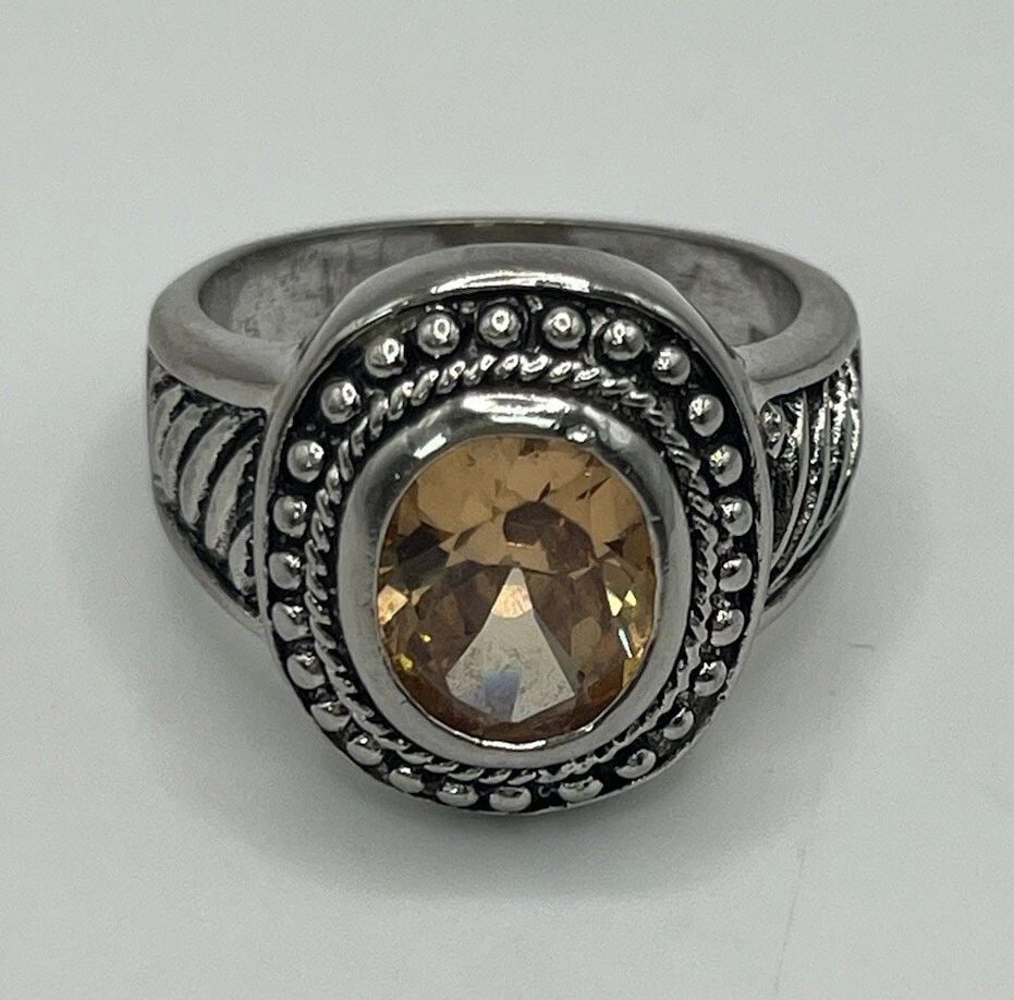 STERLING SILVER RING WITH OVAL ORANGE STONE SIZE 8: STERLING SILVER RING WITH OVAL ORANGE STONE SIZE 8 This sterling silver ring features an oval orange stone that measures approximately size 8. The gemstone is of high quality and is perfect for adding