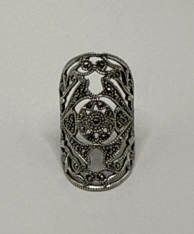 ELONGATED MARCASITE RING SIZE 8: ELONGATED MARCASITE RING SIZE 8 Elevate your jewelry collection with the Elongated Marcasite Ring, a size 8 piece that combines classic charm with modern elegance. Fashioned from 925 sterling silver,