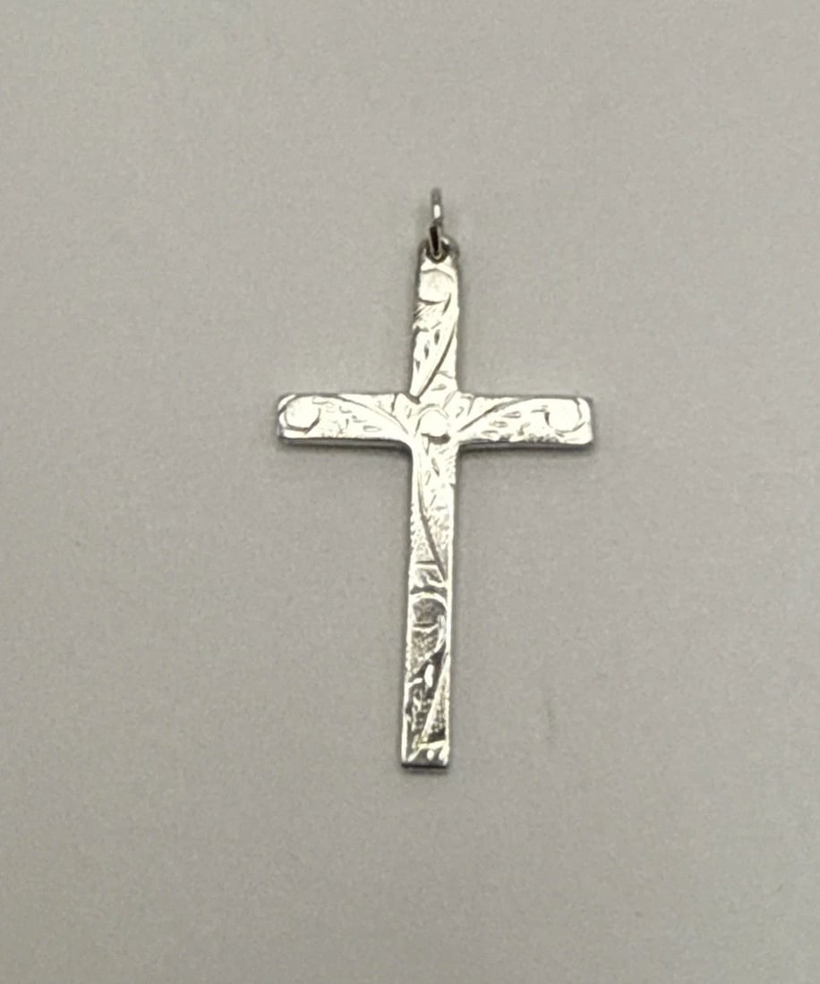 STERLING SILVER CROSS 3.3 GRAMS: STERLING SILVER CROSS 3.3 GRAMS This product is a sterling silver cross pendant, featuring a cross shape design with a metal purity of 925. The pendant also doubles as a charm and does not include a