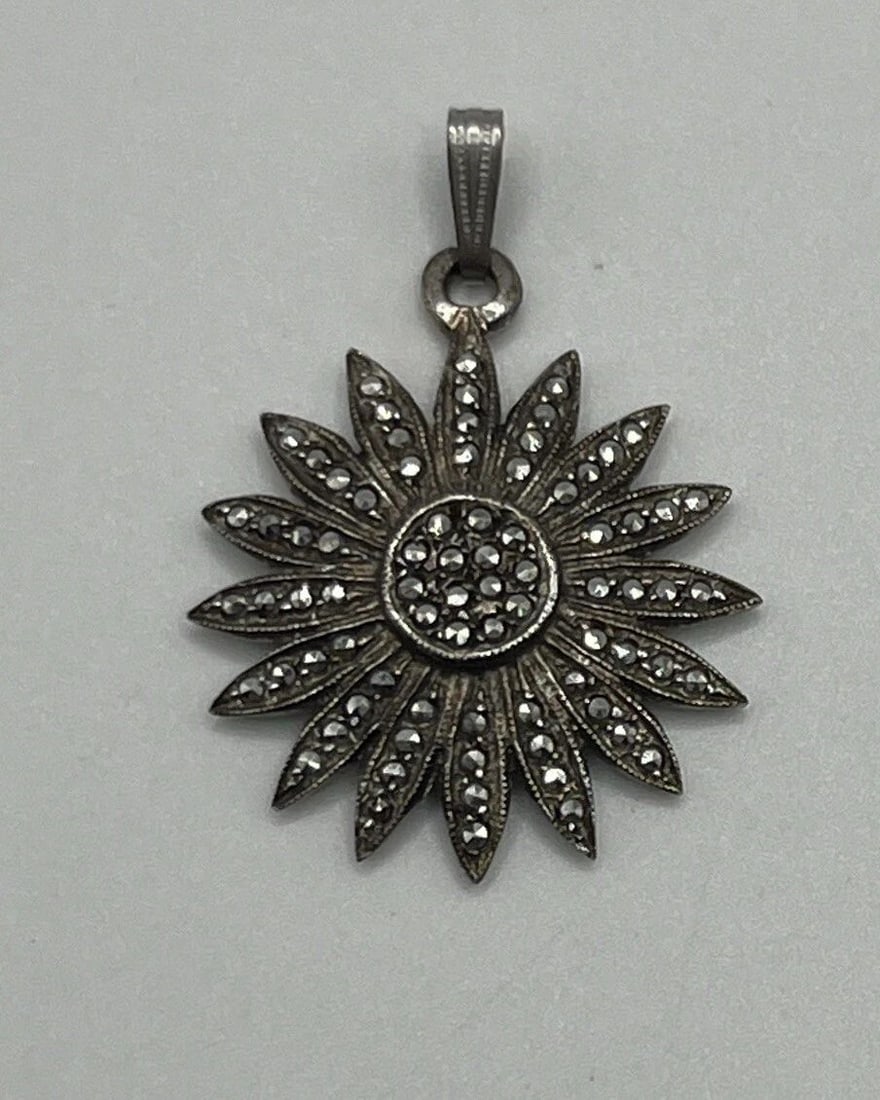STERLING SILVER & MARCASITE SUNBURST CHARM: STERLING SILVER & MARCASITE SUNBURST CHARM Add a touch of elegance to your jewelry collection with this stunning Sterling Silver & Marcasite Sunburst Charm. The charm is designed to bring a ray of
