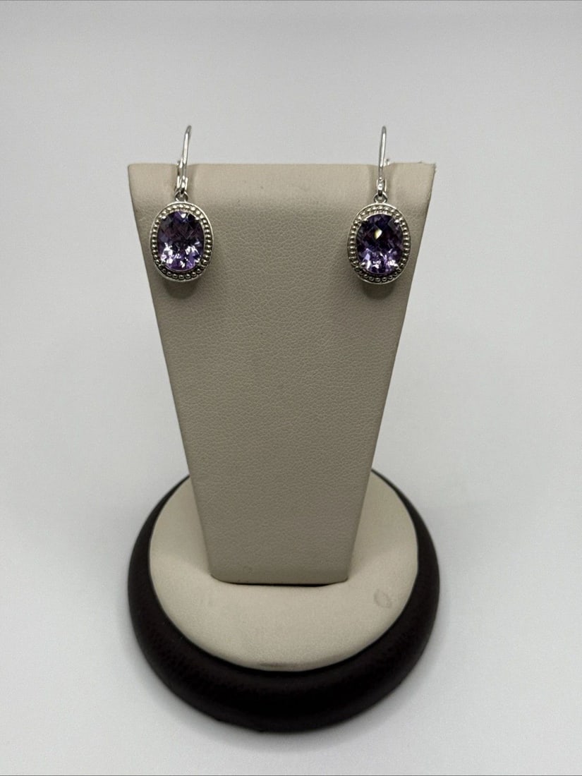 STERLING SILVER DANGLE EARRINGS WITH PURPLE STONE: STERLING SILVER DANGLE EARRINGS WITH PURPLE STONE These Sterling Silver Dangle Earrings feature a beautiful purple stone as the main focal point. The earrings are crafted from high-quality 925