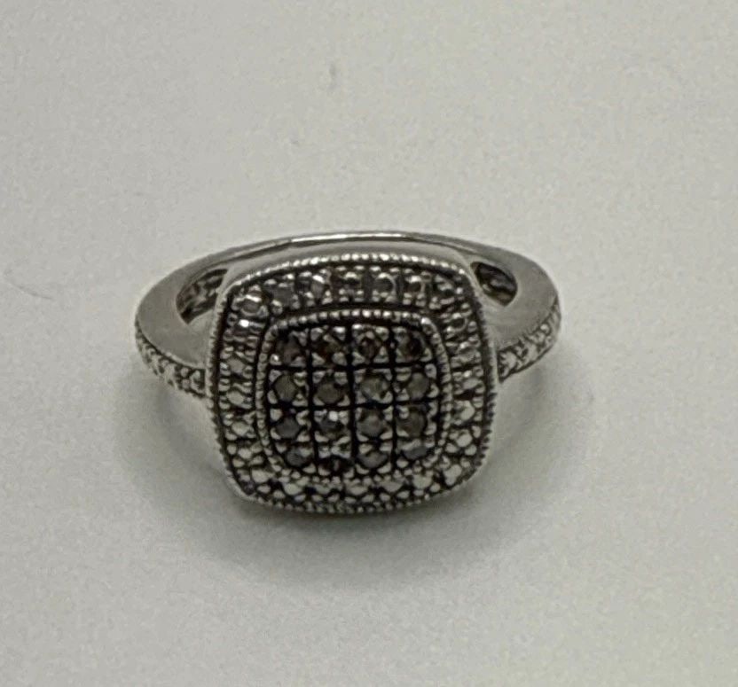 STERLING SILVER MARCASITE SQUARE RING SIZE 4.75: STERLING SILVER MARCASITE SQUARE RING SIZE 4.75 The Sterling Silver Marcasite Square Ring in size 4.75 is a beautifully crafted piece of fine jewelry. Made of high-quality 925 sterling silver, this ri