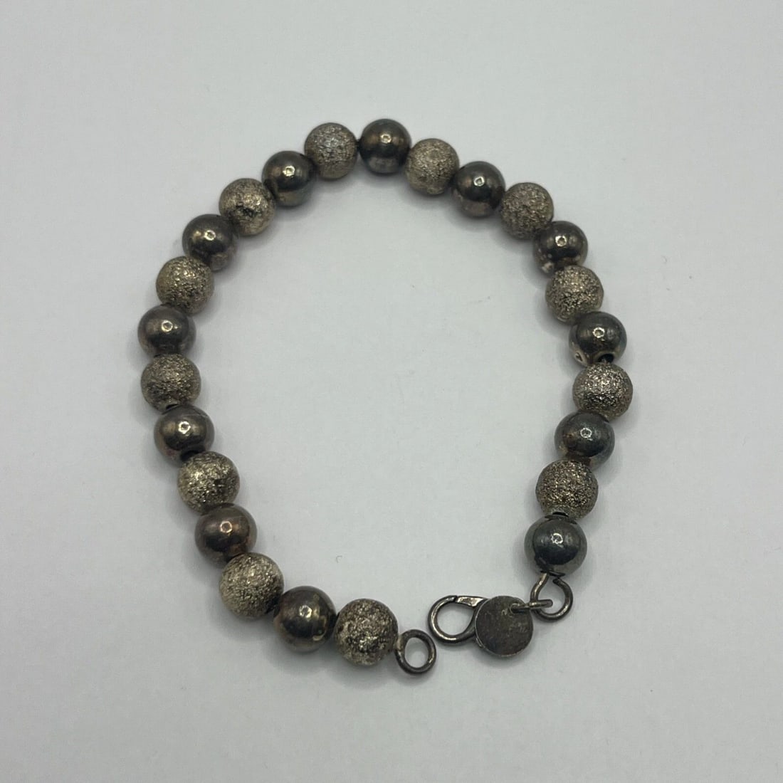 8" BALL BEAD BRACELET: 8" BALL BEAD BRACELET This 8" Ball Bead Bracelet features a multicolor beaded design, making it a stylish accessory for any outfit. The bracelet is crafted with a ball/bead chain type, adding a unique