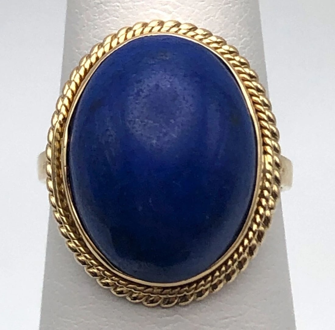 14K GOLD RING WITH OVAL SHAPED CABOCHON CUT BLUE LAPIS SIZE: 5: 14K GOLD RING WITH OVAL SHAPED CABOCHON CUT BLUE LAPIS SIZE: 5 14k Gold Ring with center Oval shaped Cabochon cut Blue Lapis Condition: Used Material:14k Yellow Gold Ring Size: 5 Weight: 4.3 grams Top