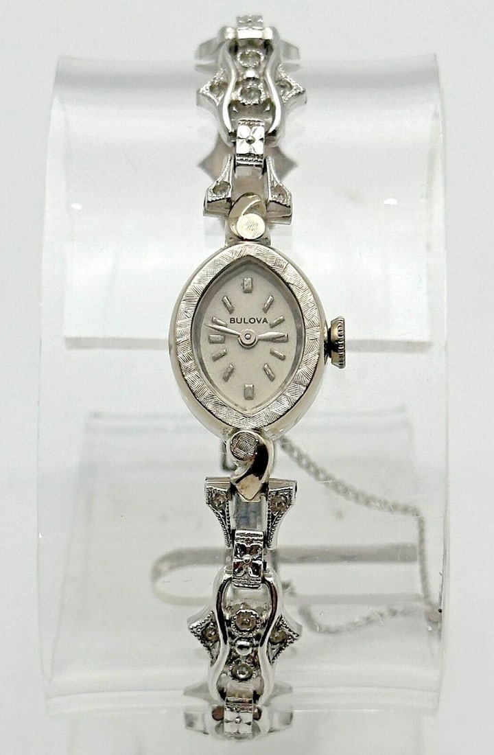VINTAGE BULOVA WATCH 14K WHITE GOLD CASE AND STERLING BAND WITH CUBIC ZIRCONIA: VINTAGE BULOVA WATCH 14K WHITE GOLD CASE AND STERLING BAND WITH CUBIC ZIRCONIA Vintage Bulova Watch 14k White Gold Case and Sterling Band with Cubic Zirconia Condition: Used / Vintage, runs and keeps