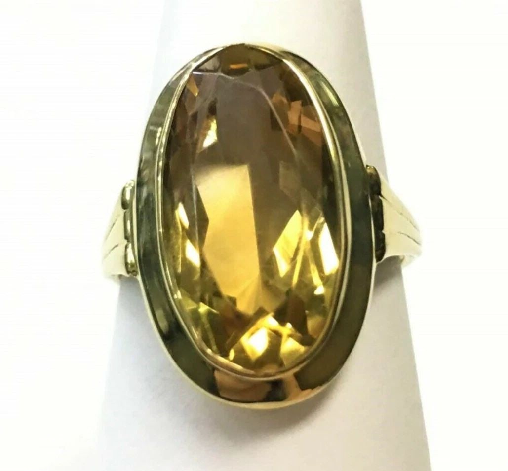 WOMAN'S 14K YELLOW GOLD RING WITH YELLOW PLASTIC STONE: WOMAN'S 14K YELLOW GOLD RING WITH YELLOW PLASTIC STONE Woman's 14k Yellow Gold Ring with Yellow Plastic Stone You are bidding on a Woman's 14k Yellow Gold Ring with Yellow Plastic Stone. Ring has some