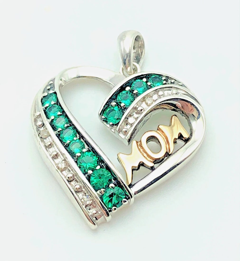 SILVER HEART PENDANT WITH 14K GOLD MOM, DIAMONDS AND SYNTHETIC EMERALDS: SILVER HEART PENDANT WITH 14K GOLD MOM, DIAMONDS AND SYNTHETIC EMERALDS Silver Heart Pendant with 14k Gold Mom, Diamonds and Synthetic Emeralds You are bidding on a Silver Heart Pendant with 14k Gold