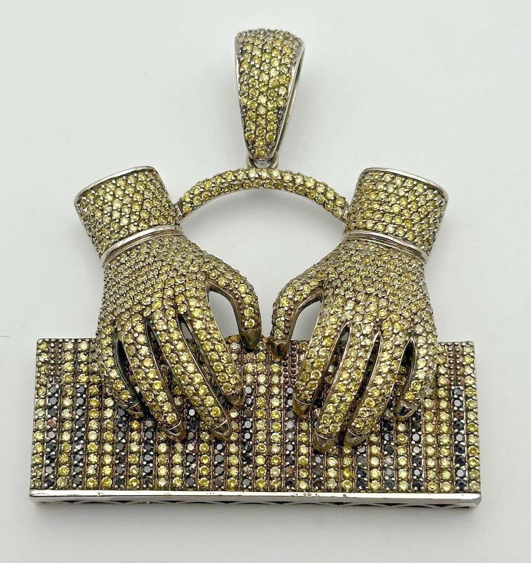 PIANO KEYBOARD HANDS PENDANT 925 STERLING SILVER WITH YELLOW AND BLACK C.Z.: Piano Keyboard Hands Pendant 925 Sterling Silver with Yellow and Black C.Z. Condition: Used Material: 925 Sterling Silver Pendant Size: 3 inches x 3.5 inches Total Weight: 70.9 grams Stone Info: all S