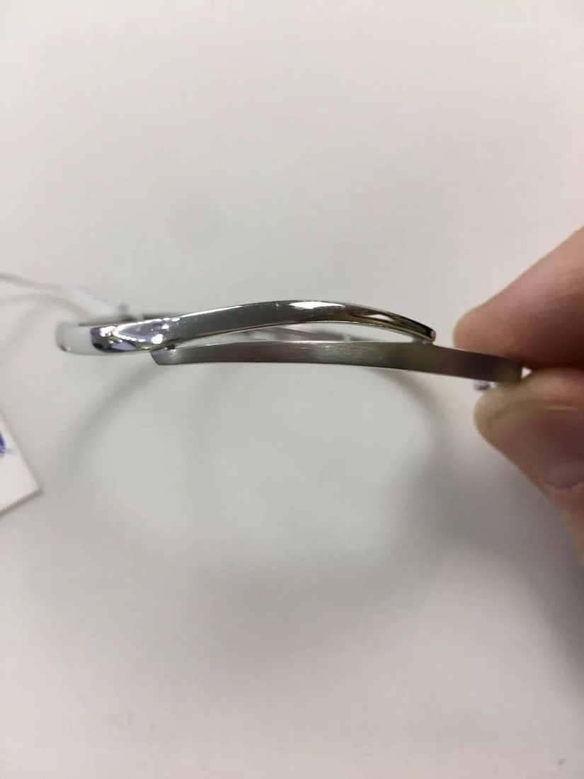 BREUNING BYPASS BANGLE BRACELET IN STERLING SILVER: BREUNING BYPASS BANGLE BRACELET IN STERLING SILVER Breuning Bypass Bangle Bracelet in Sterling Silver You are bidding on a Breuning Bypass Bangle Bracelet in Sterling Silver. The bracelet has some min